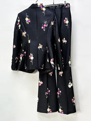Back view of a black floral print blazer and flare pants suit on a hanger.