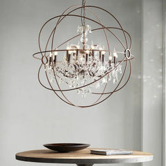Mid century rustic birdcage chandelier with crystal candle lights suspended above wooden dining table