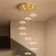 Pendant light hanging in a living room, adding a touch of modern elegance to the space. Golden Atelier 4