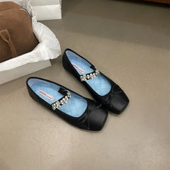 Black square toe ballet flats with a bow and crystal embellishment