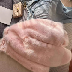 Women’s pink shaggy faux fur coat with turn-down lapel and full sleeves.