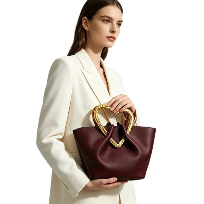 Woman with burgundy heart handle bag side profile