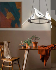  Nordic bird pendant lamp with black and silver finish, hanging in a cozy living room setting. Golden Atelier 3