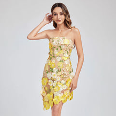 Woman wearing a strapless floral dress with yellow and white flowers on a light gray background