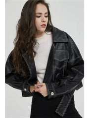 A woman wearing a black faux leather jacket with a split hem, showcasing its edgy style. Golden Atelier 1