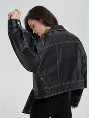 A woman wearing a black faux leather jacket with a split hem, showcasing its edgy style. Golden Atelier 3