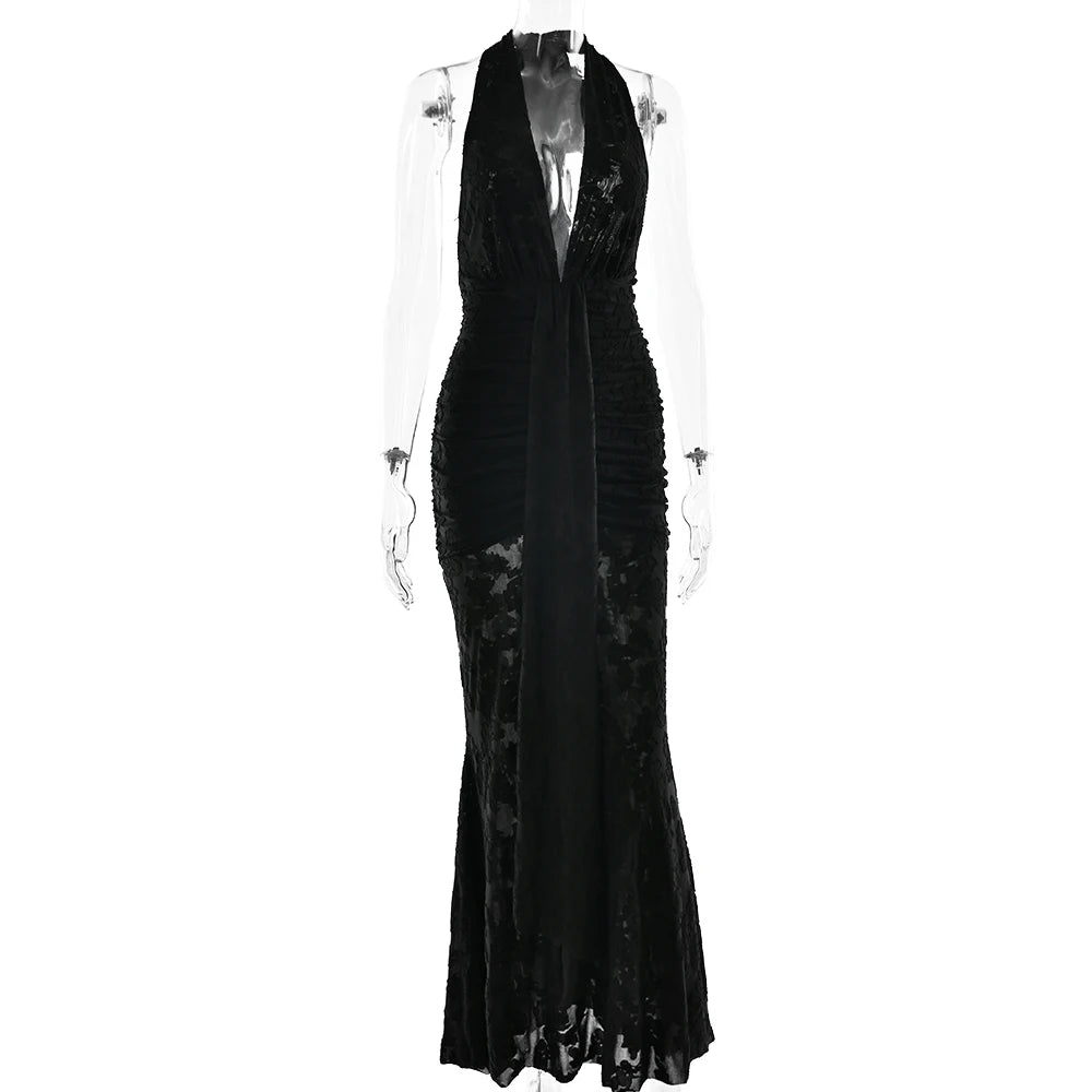 Black evening gown on a mannequin against a white background