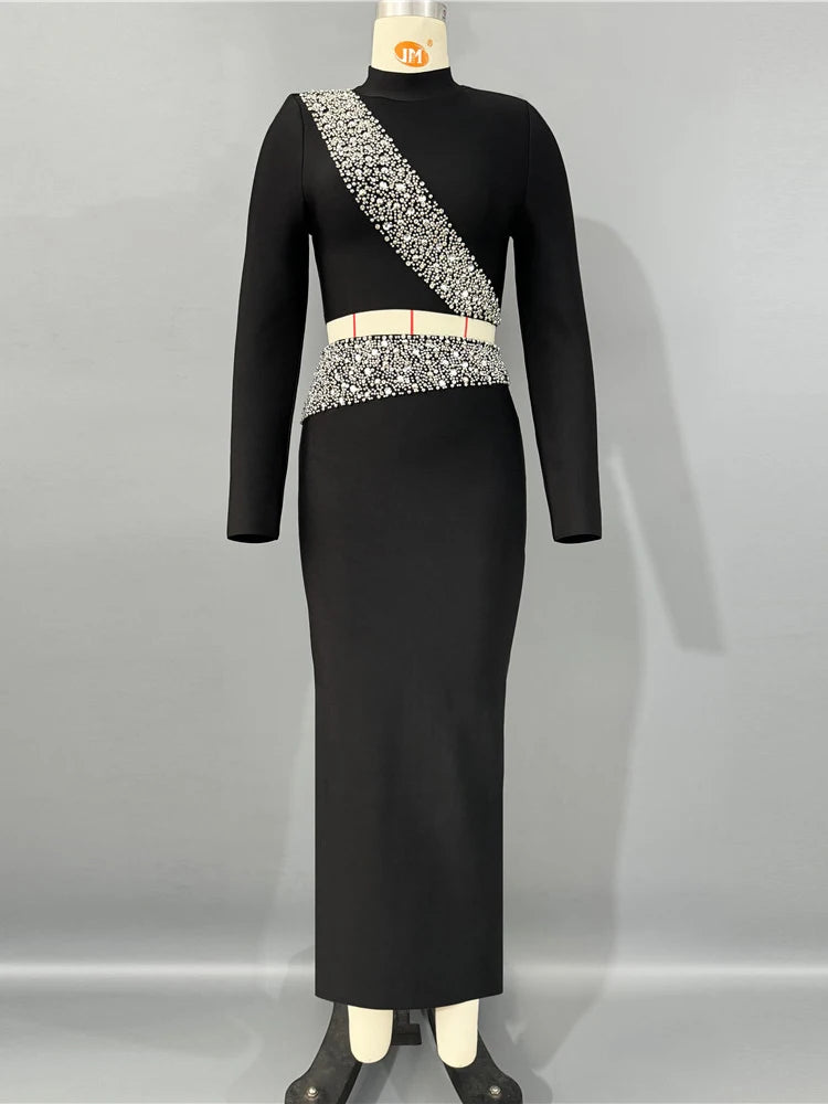 Black dress with silver embellishments on a mannequin against a gray background