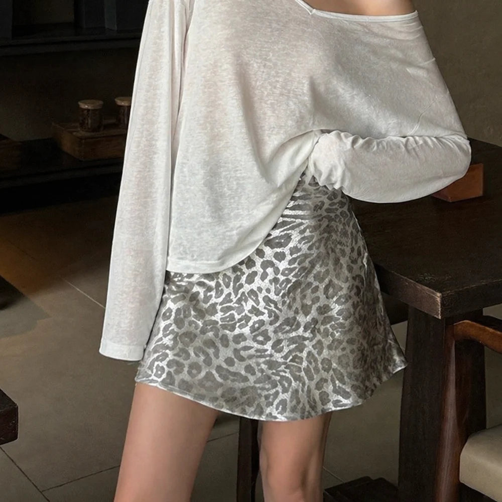 Model wearing silver leopard print A-line skirt with white top