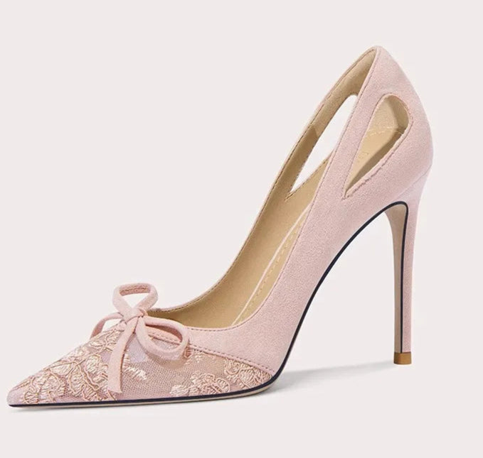 Pink high-heeled shoe with a bow on a light gray background