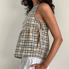 Plaid sleeveless top worn by a person on a plain background