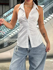 Woman wearing a white sleeveless shirt and light blue jeans with a blurred background