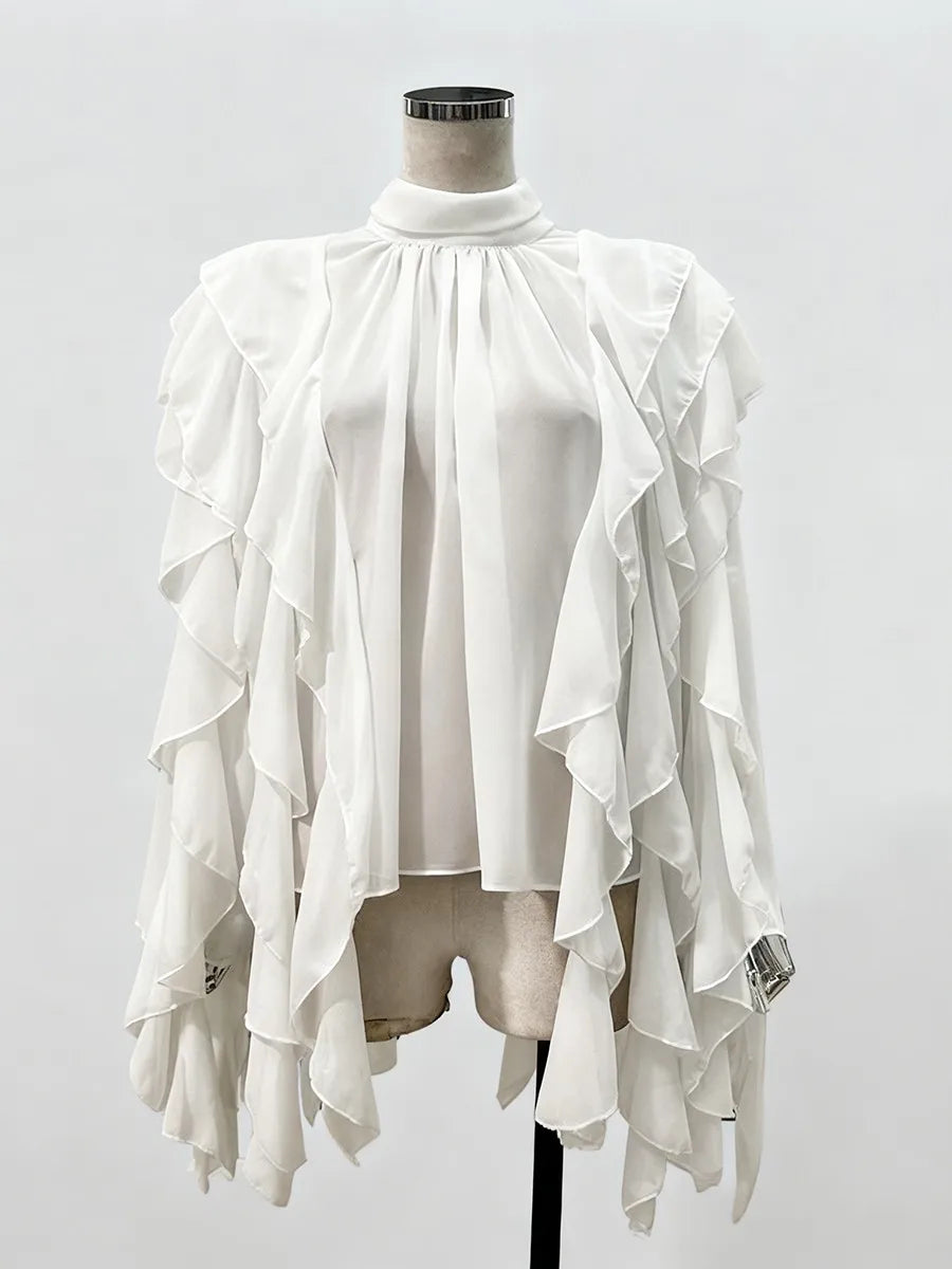 White ruffled top on a mannequin against a white background