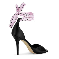 Side view of black satin peep toe stiletto sandal with pink polka dot ribbon tie