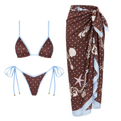 Two-piece polka dot bikini with contrast trim, featuring triangle cups and tie-side bottoms, paired with a coordinating polka dot skirt.
