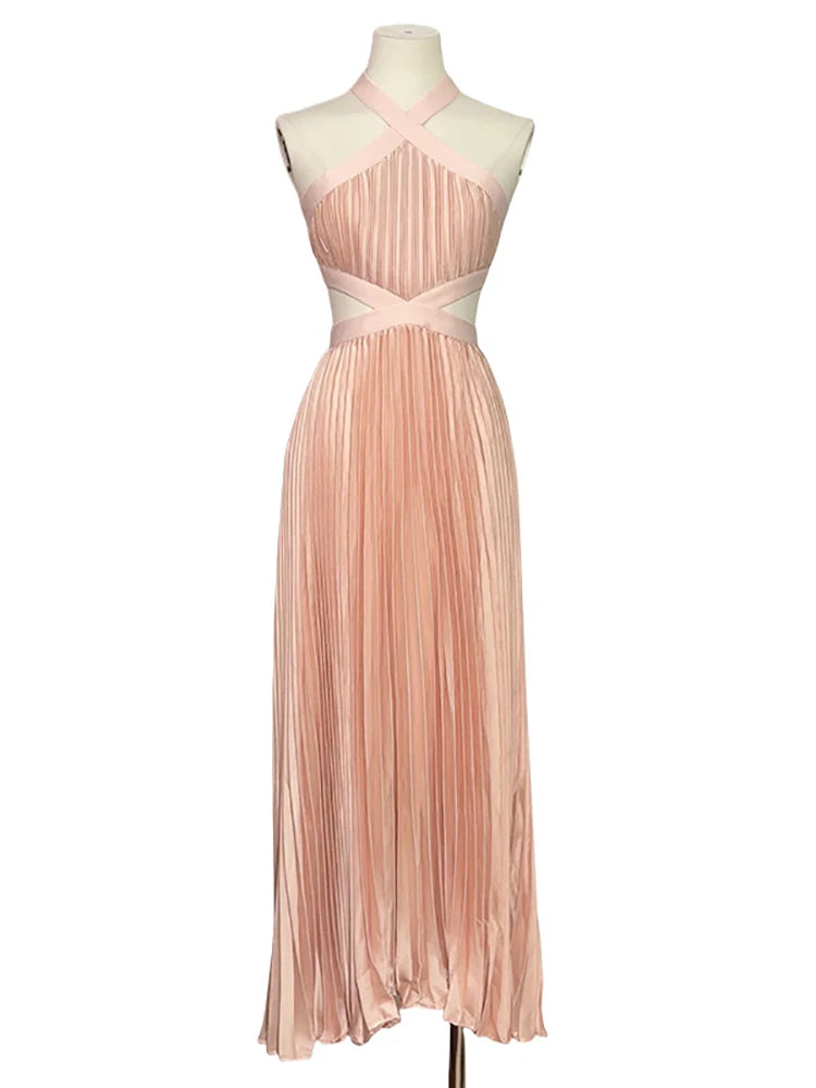 Pink pleated dress on a mannequin against a white background