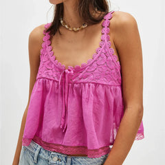 Pink lace top worn by a person on a white background