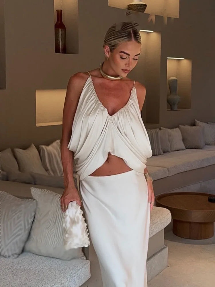 Woman in a white dress standing in a modern living room.