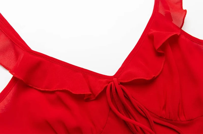 Close-up of the V-neckline and ruffled straps with bow tie detail on a red dress