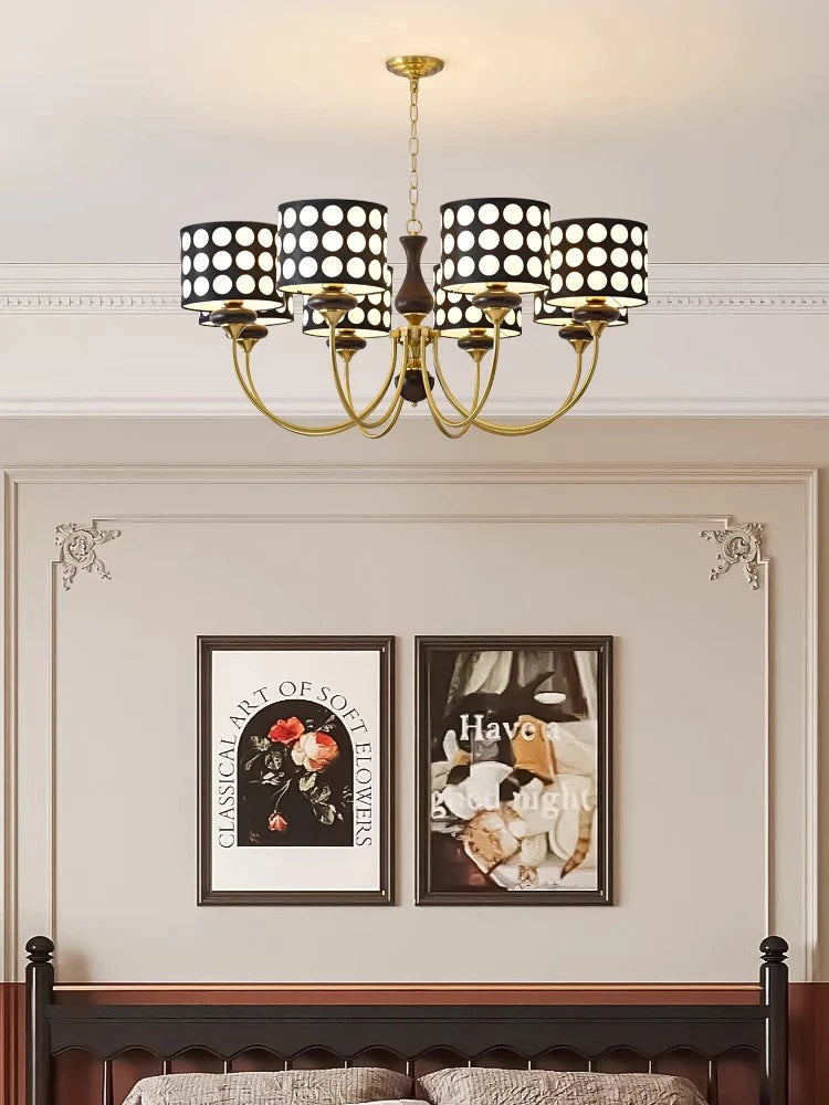 Lifestyle image showcasing the polka dot chandelier as a unique focal point in a minimalist dining room. Golden Atelier