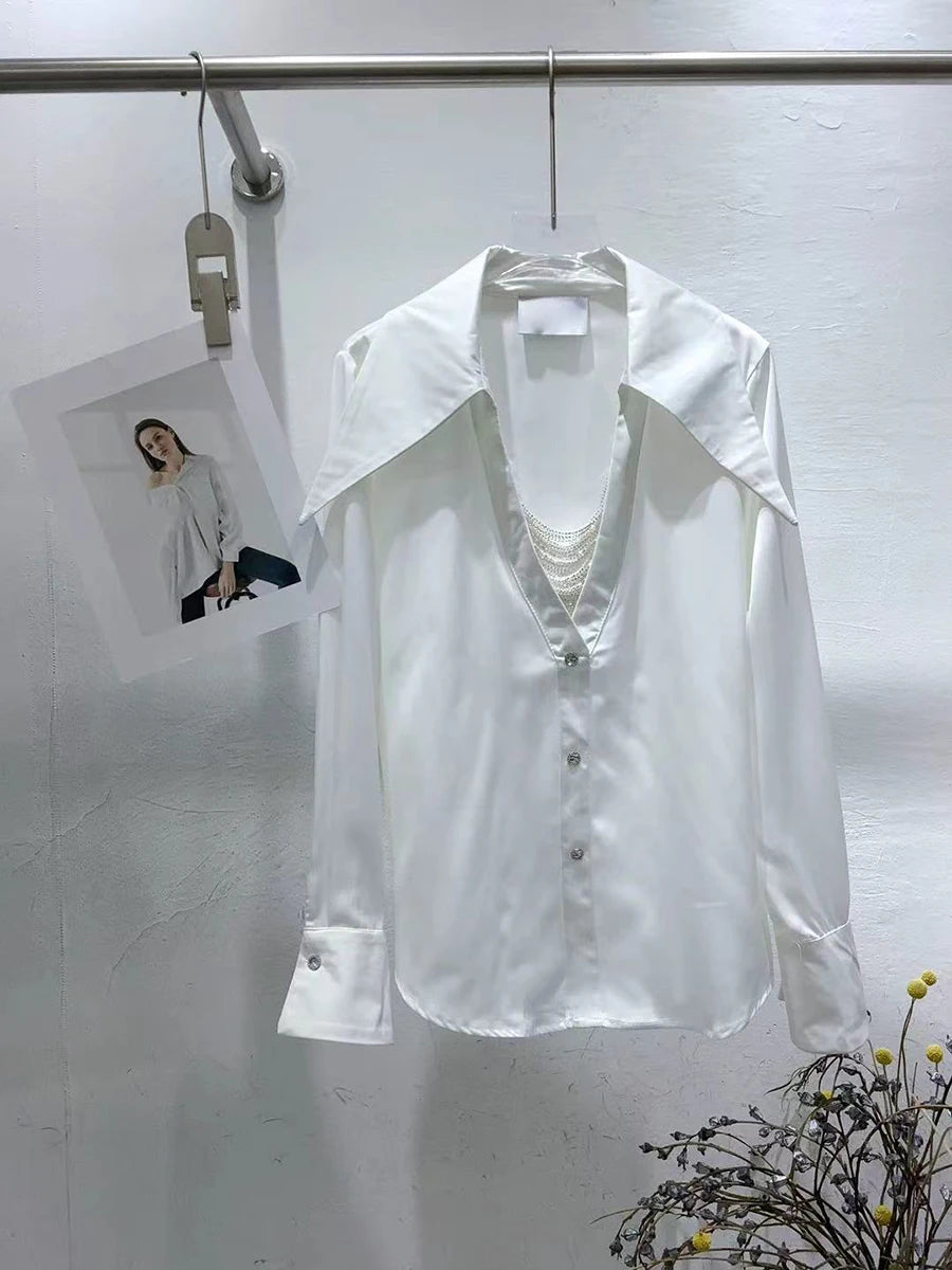 White shirt on a hanger with a small photo of a woman in a white shirt in the corner.