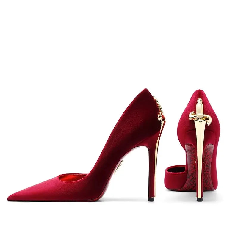 Red high-heeled shoes with gold accents on a white background