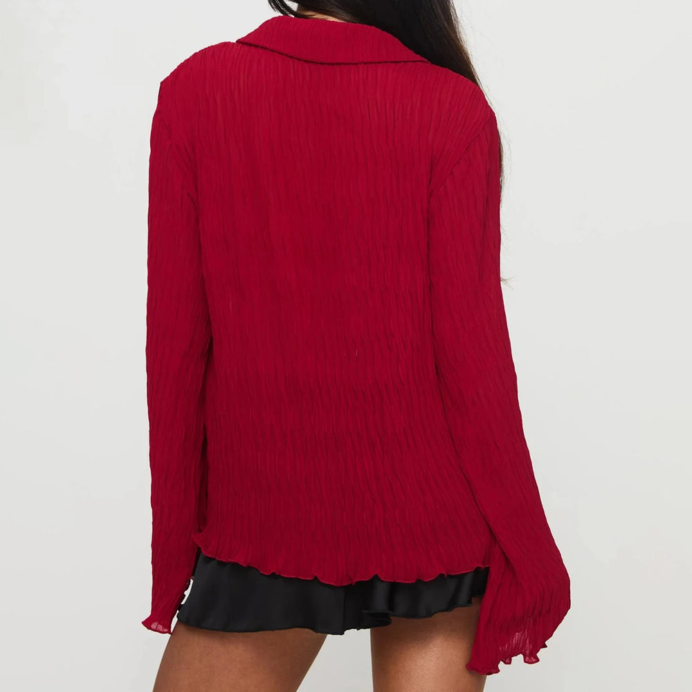 Red blouse worn by a person on a white background