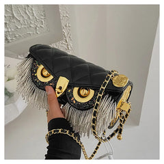Black quilted owl chain bag with fringe detail