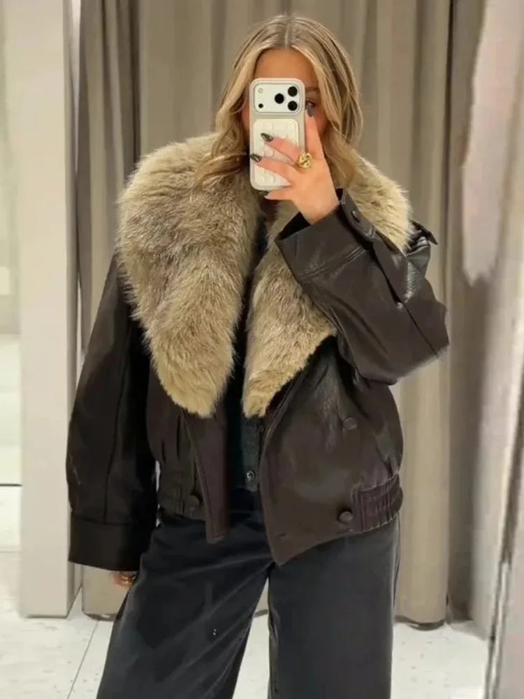 Faux leather bomber jacket with a large beige faux fur collar worn by a model