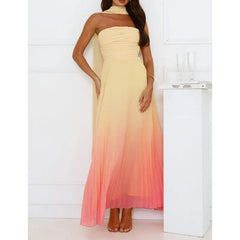 Woman wearing a strapless, floor-length dress with a gradient from beige to pink against a white background.