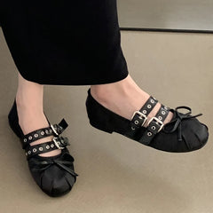 Pair of black silk ballet flats with double buckle straps and butterfly knot