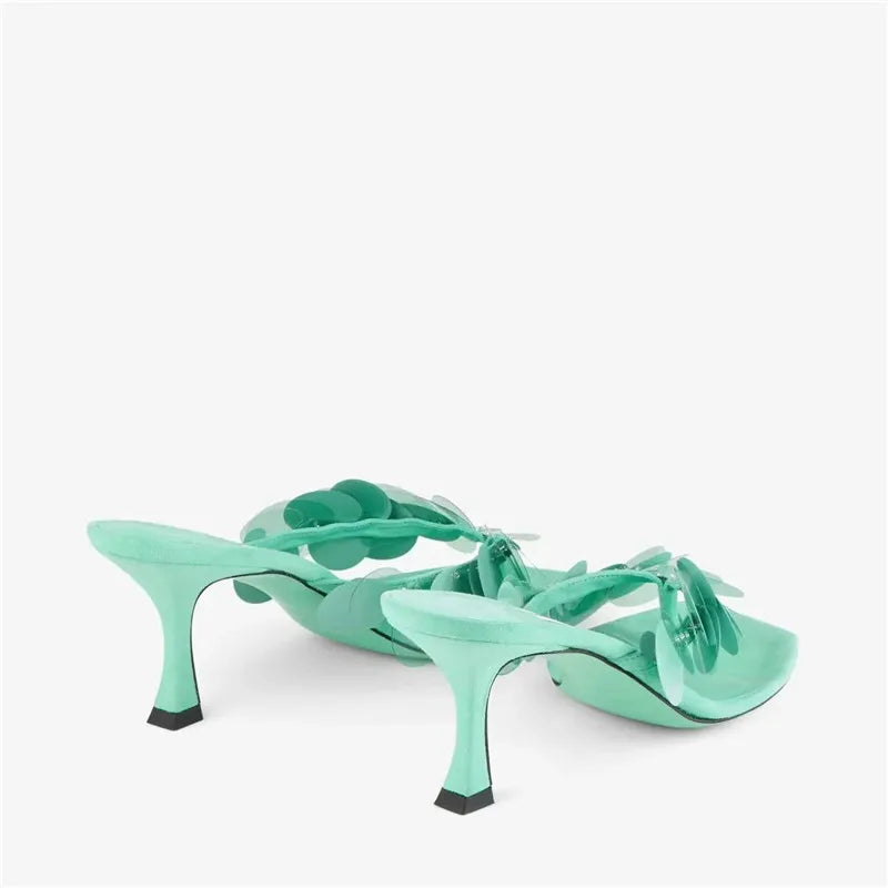 Side view of aqua green heeled thong sandals showcasing the stiletto heel.