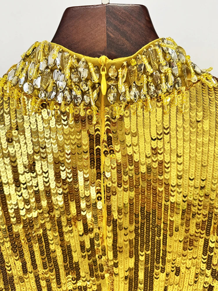 Close-up of a yellow sequin garment on a mannequin with a plain background
