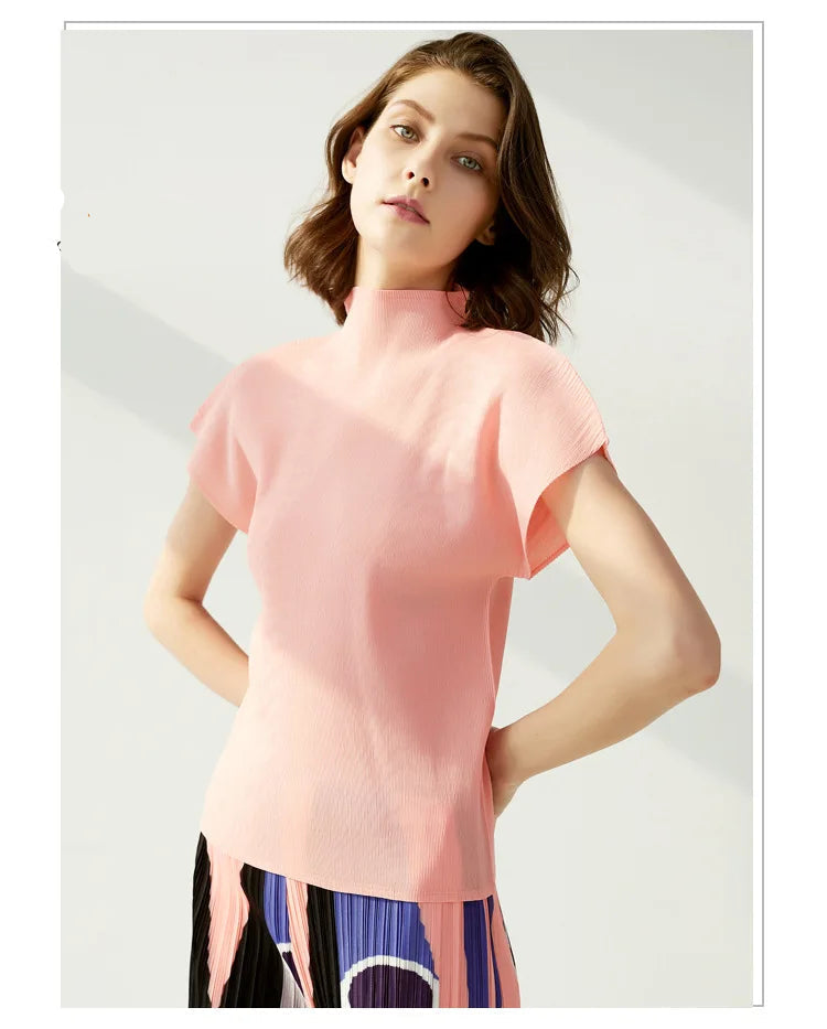 Woman wearing a pink top with a plain background