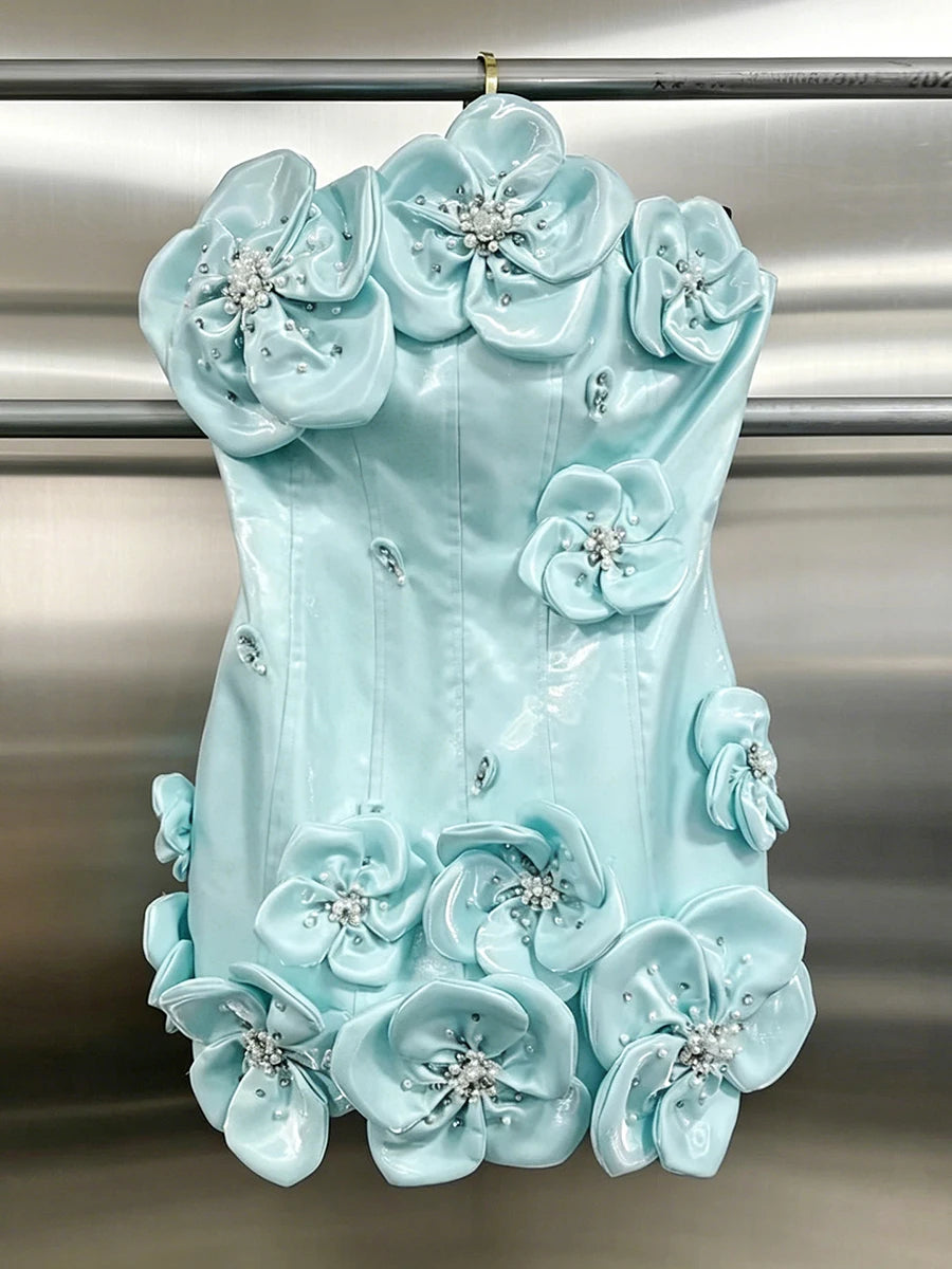 Close-up of the bodice of a strapless mini dress with 3D flowers and beading
