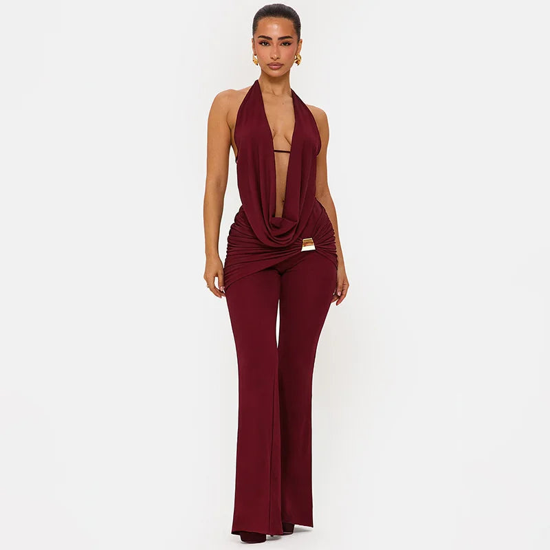 Woman wearing a burgundy jumpsuit on a white background