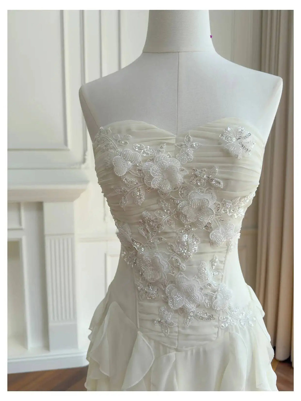 Close-up of floral applique and embellishments on the bodice of a strapless dress