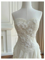 Close-up of floral applique and embellishments on the bodice of a strapless dress