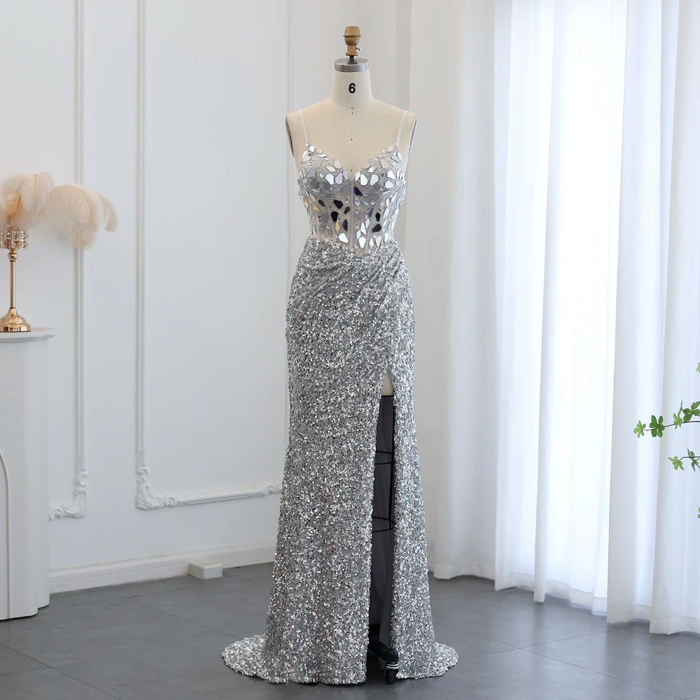 Silver sequin evening gown on a mannequin against a white curtain background