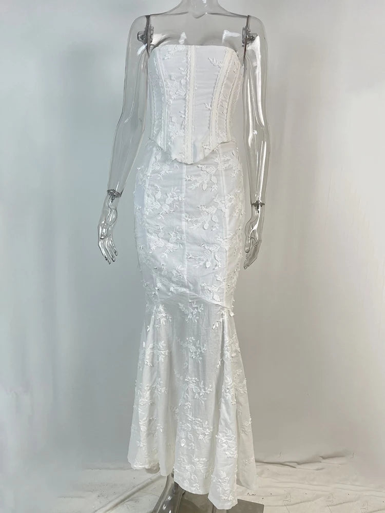 White strapless dress on a mannequin against a plain background