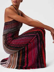 Woman wearing a colorful striped dress on a white background
