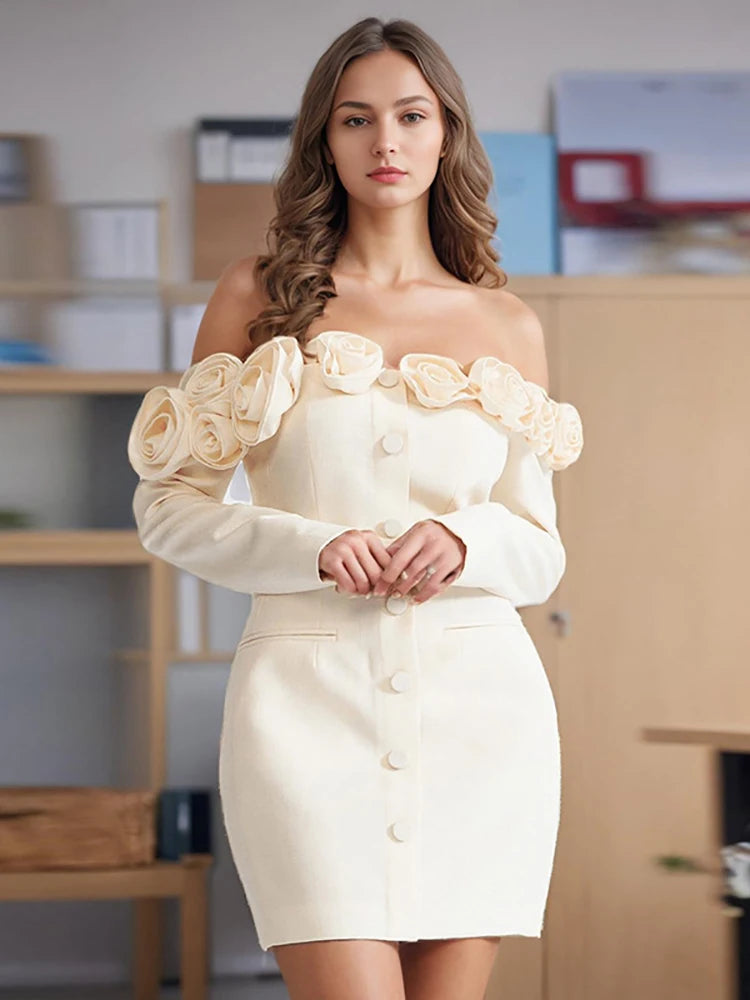Woman wearing a white dress with floral details in an office setting