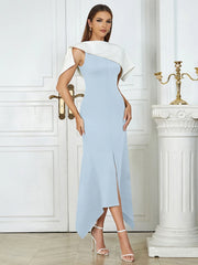 Woman wearing a light blue and white dress in an elegant interior setting.