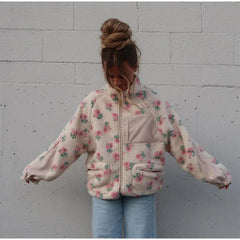 Close-up of the plush fleece texture and floral pattern on the jacket.