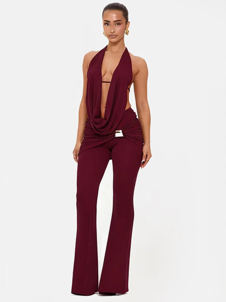 Woman wearing a burgundy jumpsuit on a white background