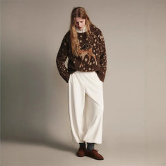 Model wearing dark brown crew neck knit sweater with fawn graphic print