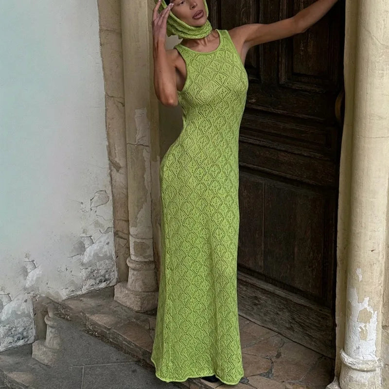 Woman in a green dress standing in an old stone building