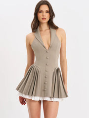 Woman wearing a beige dress with buttons on a white background