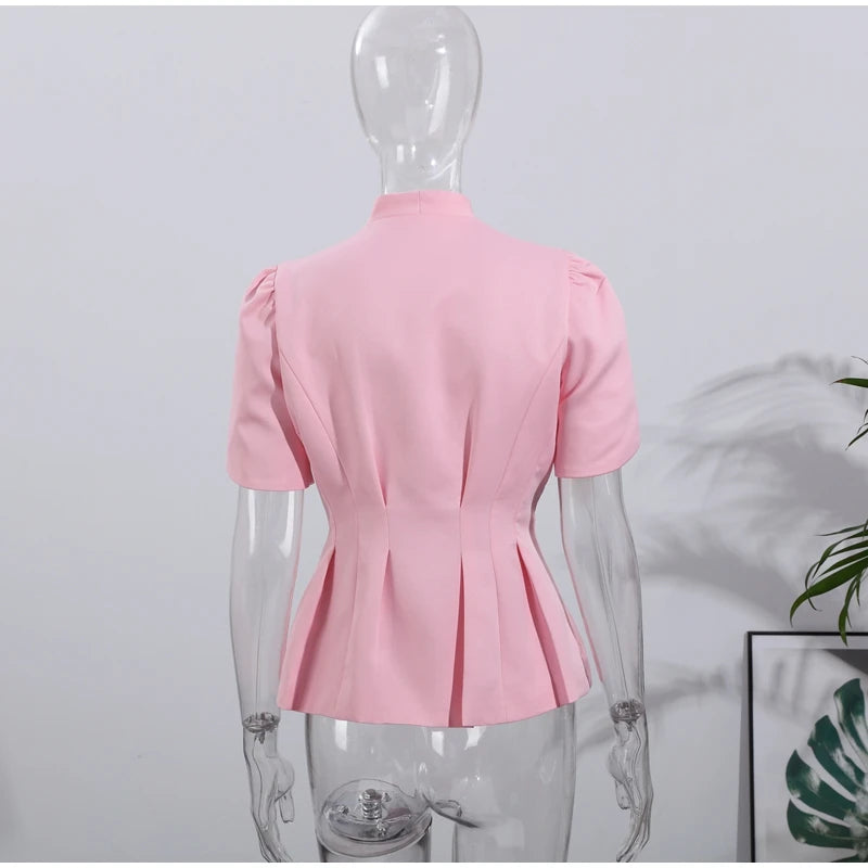 Pink blouse on a mannequin against a light gray background