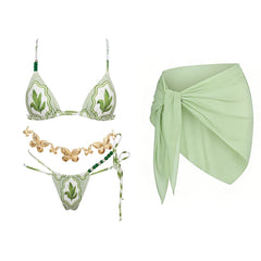 Green print triangle bikini with beaded embellishments and a matching wrap skirt.
